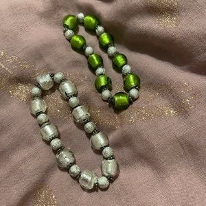 Gorgeous, glass beaded bracelets with glittering silver-tone spacers.